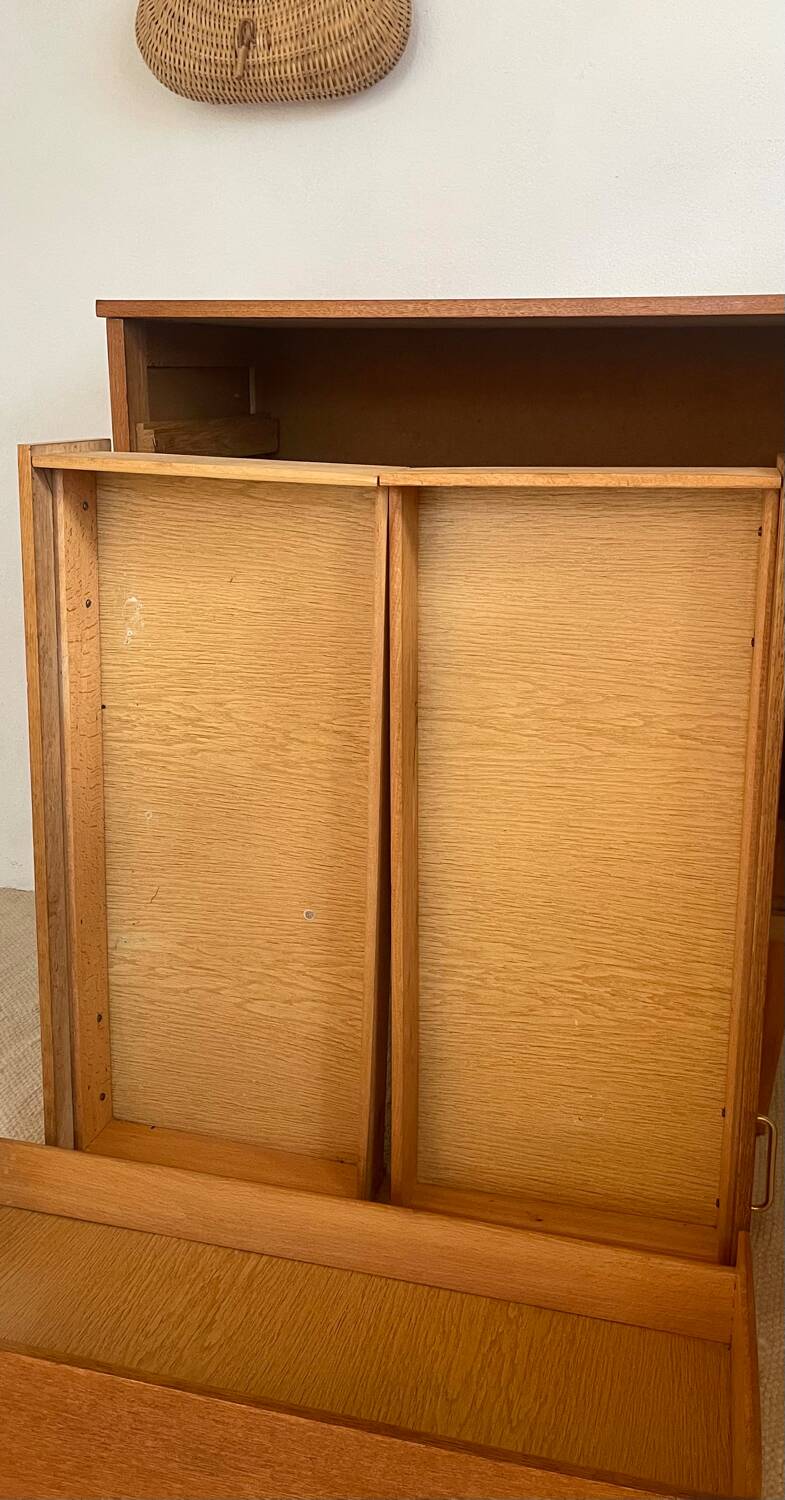 Vintage 1960s chest of drawers with covered handles.