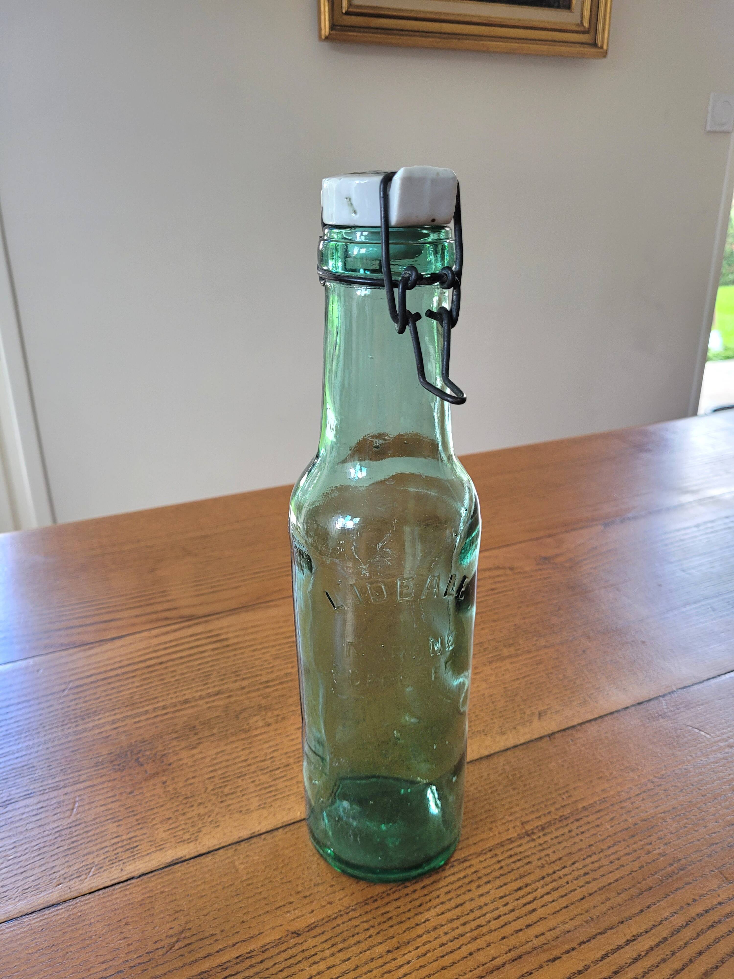 Vintage glass bottle l'Idéale with porcelain stopper