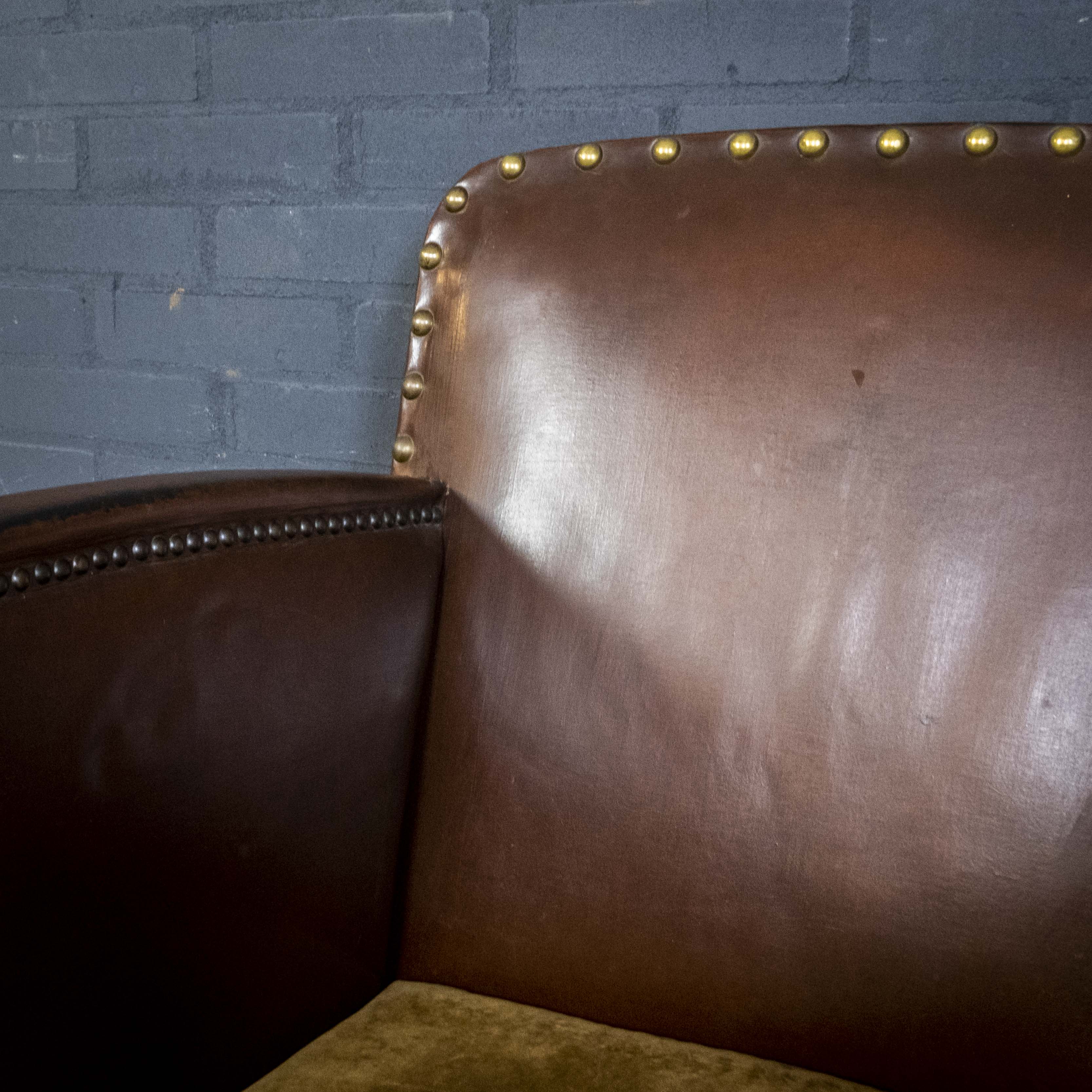 Antique club armchair of leather cloth