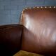 Antique club armchair of leather cloth