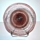 Antique plate in pink bubbled blown glass