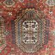 Antique wool rugs with designs on a red background, 20th century.