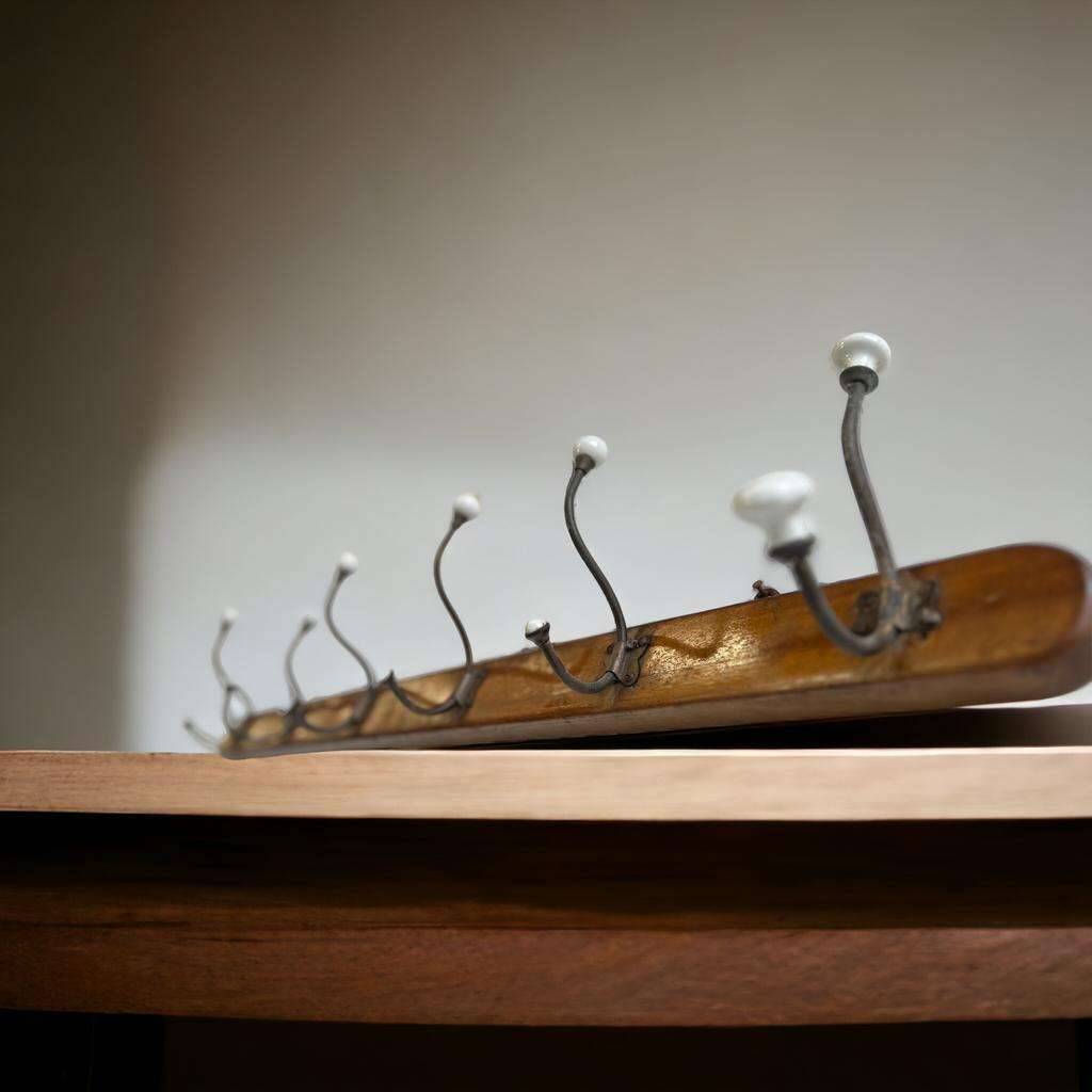 Vintage industrial wooden coat rack with porcelain hooks