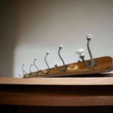 Vintage industrial wooden coat rack with porcelain hooks