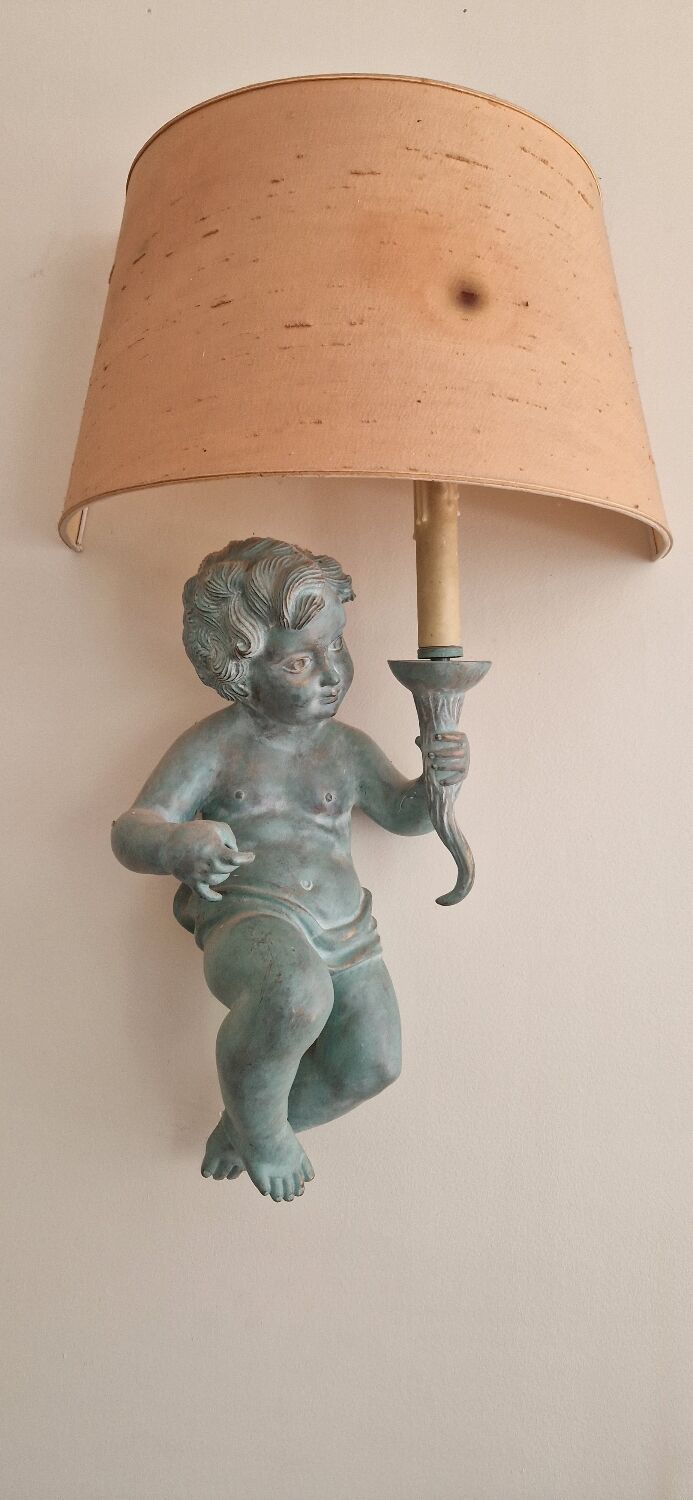 Pairs of wall lights, either two distinct cherubs.