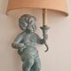 Pairs of wall lights, either two distinct cherubs.