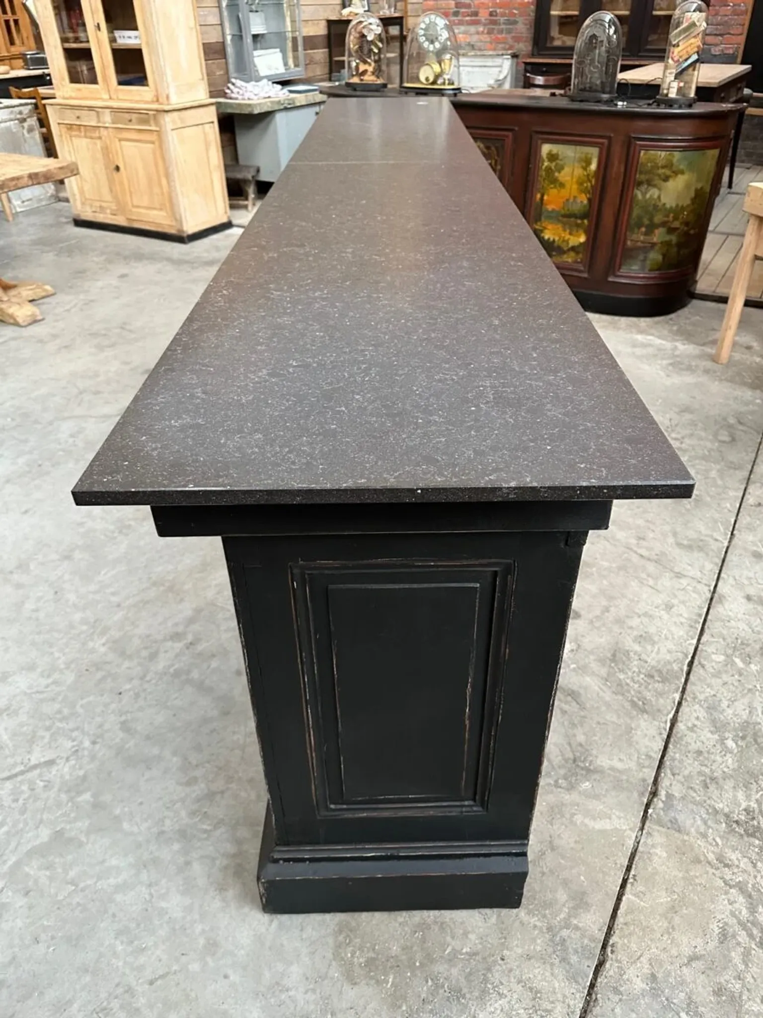 Immense bar counter covered with blue stone.