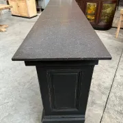 Immense bar counter covered with blue stone.