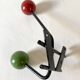 Small double coat hook in metal and wood painted green and red, 1950s-60s