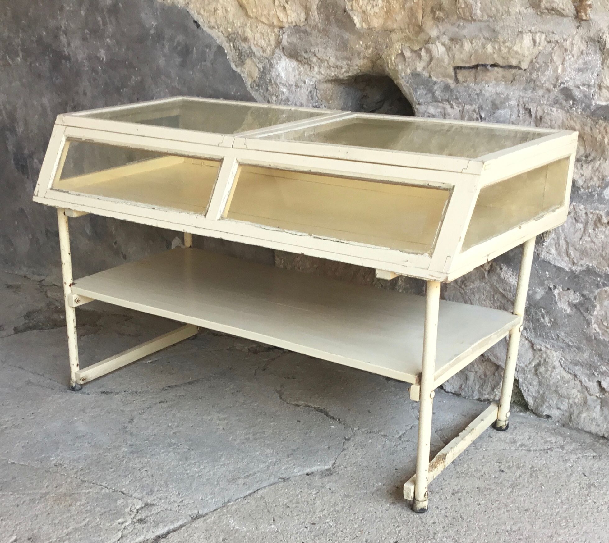 Old showcase on tubular metal feet - early twentieth century