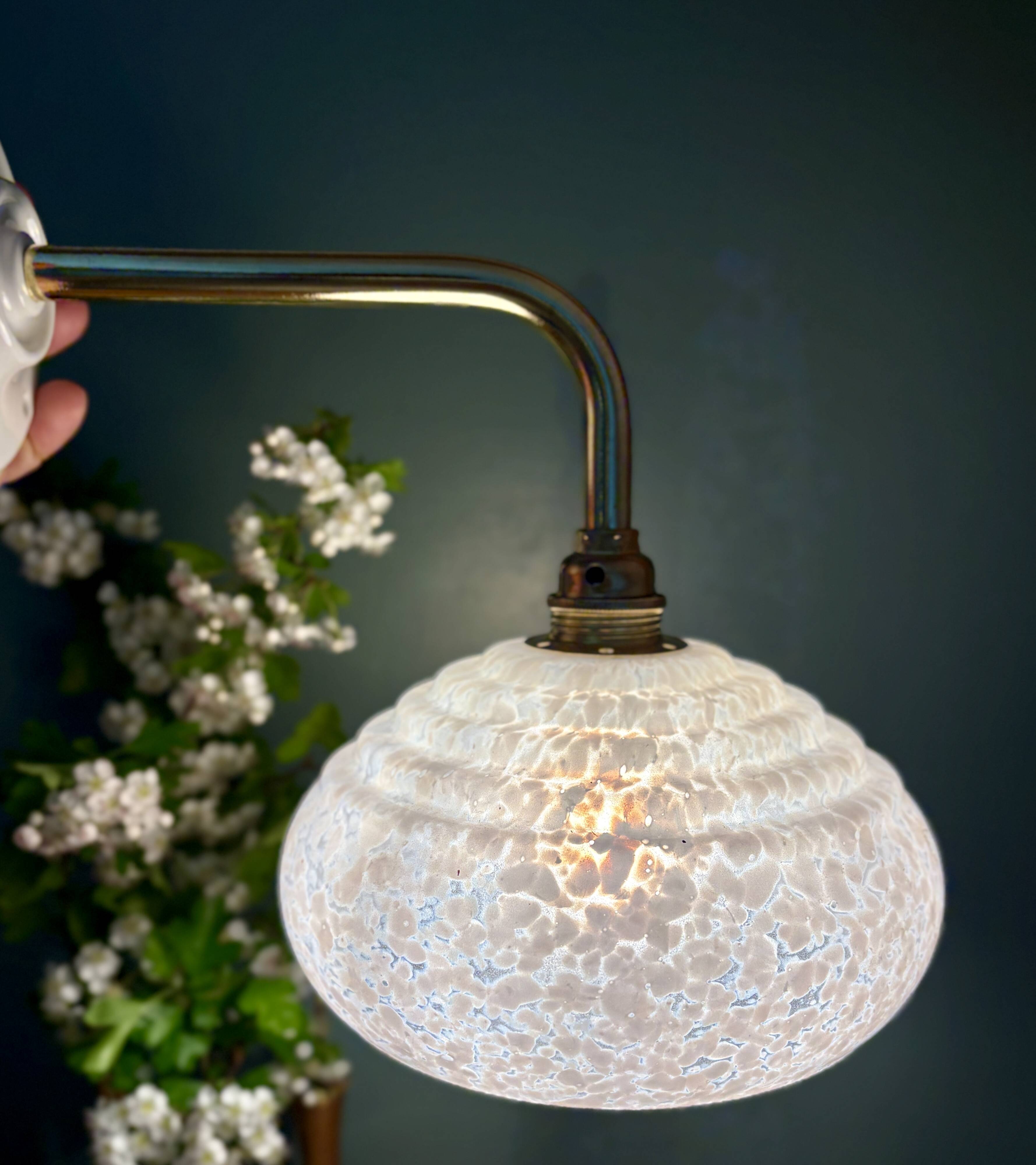 Vintage glass wall lamp with a white Clichy shade.