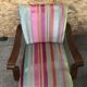 Old wooden armchair with curved armrests
