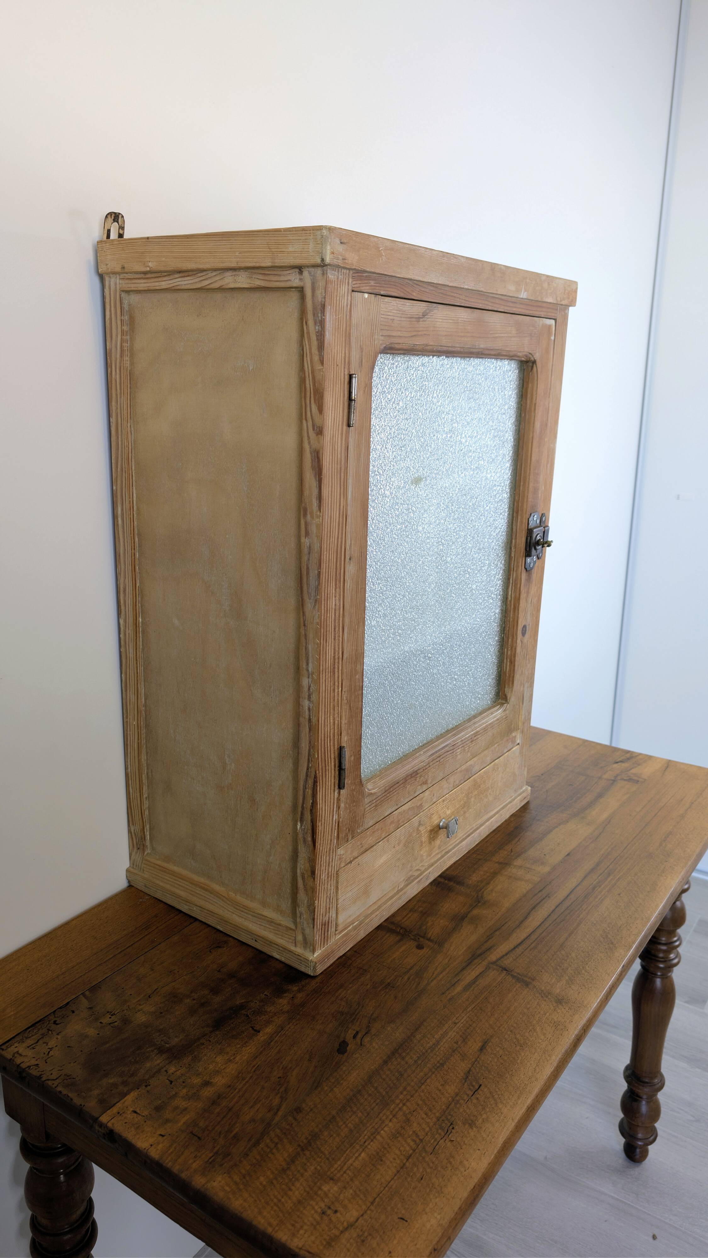 Small glass wall cabinet from the 1960s.
