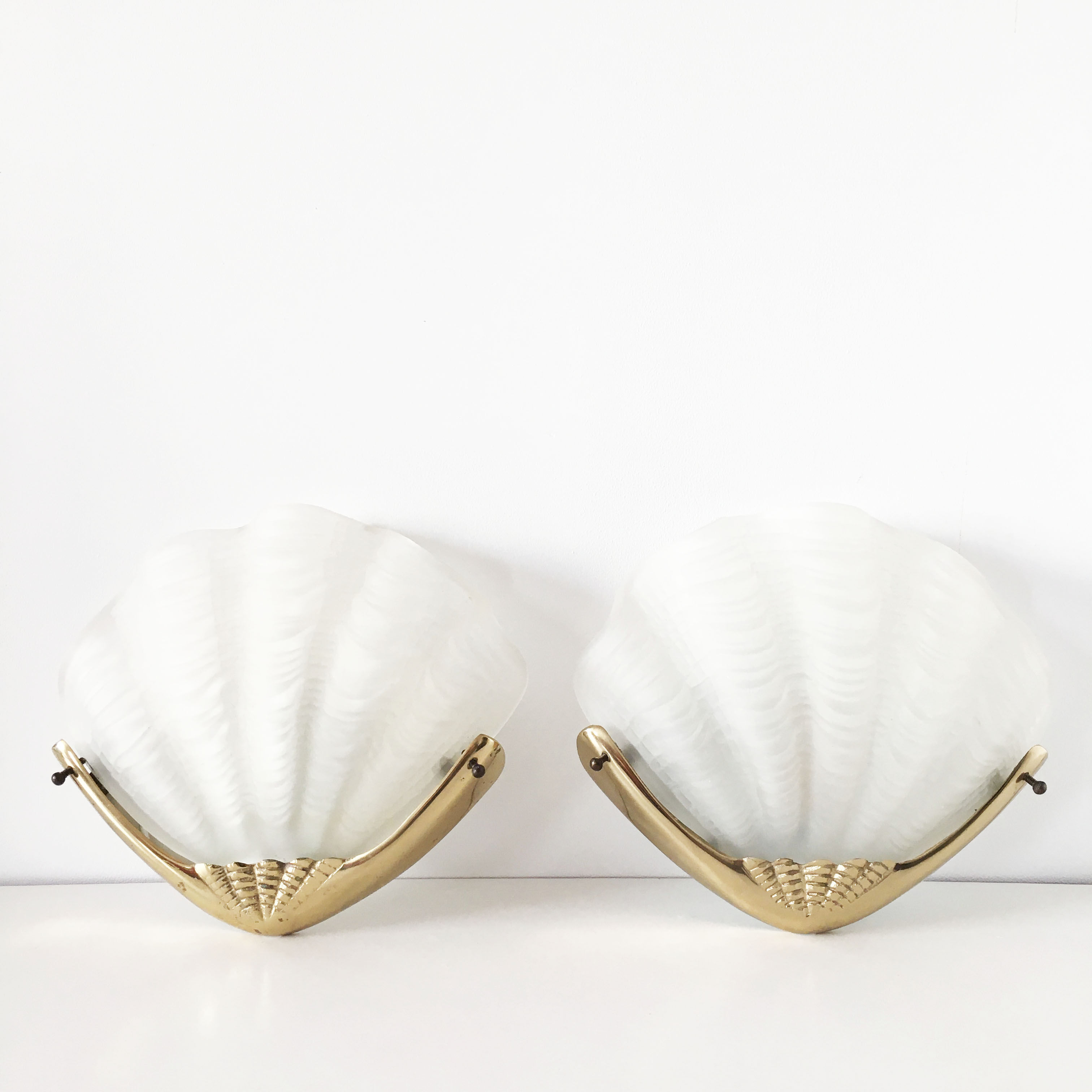 Pair of glass and gold metal shell sconces