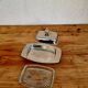Vintage silver-plated metal butter dish with a gold tassel knob