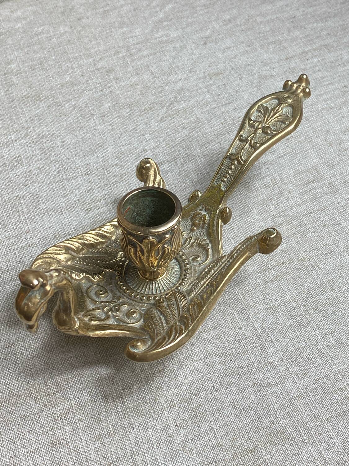 Bronze hand candlestick in the shape of a peacock