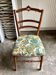 Carved wooden chair with printed cotton.