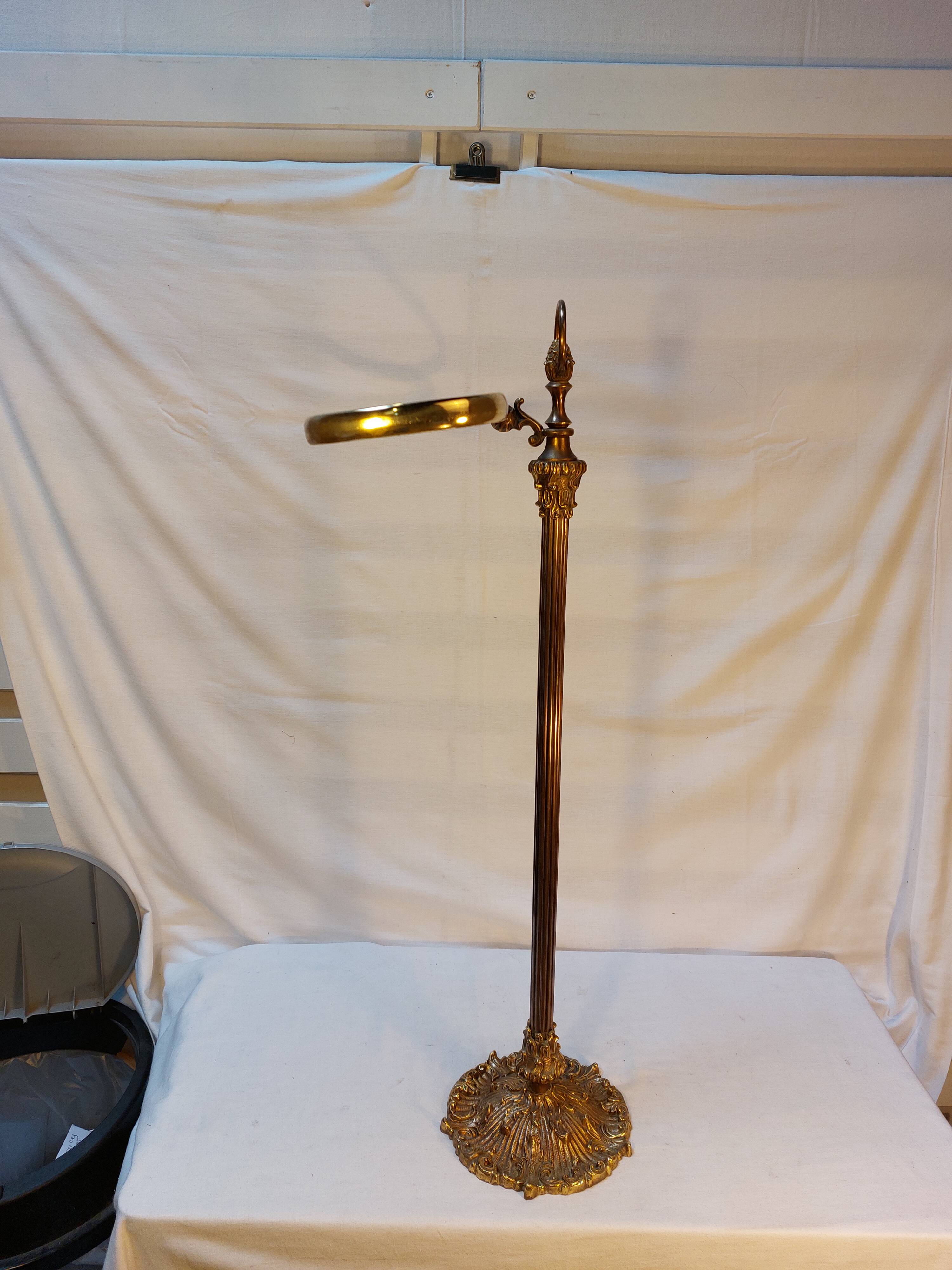 Old golden brass towel rack on baroque style foot