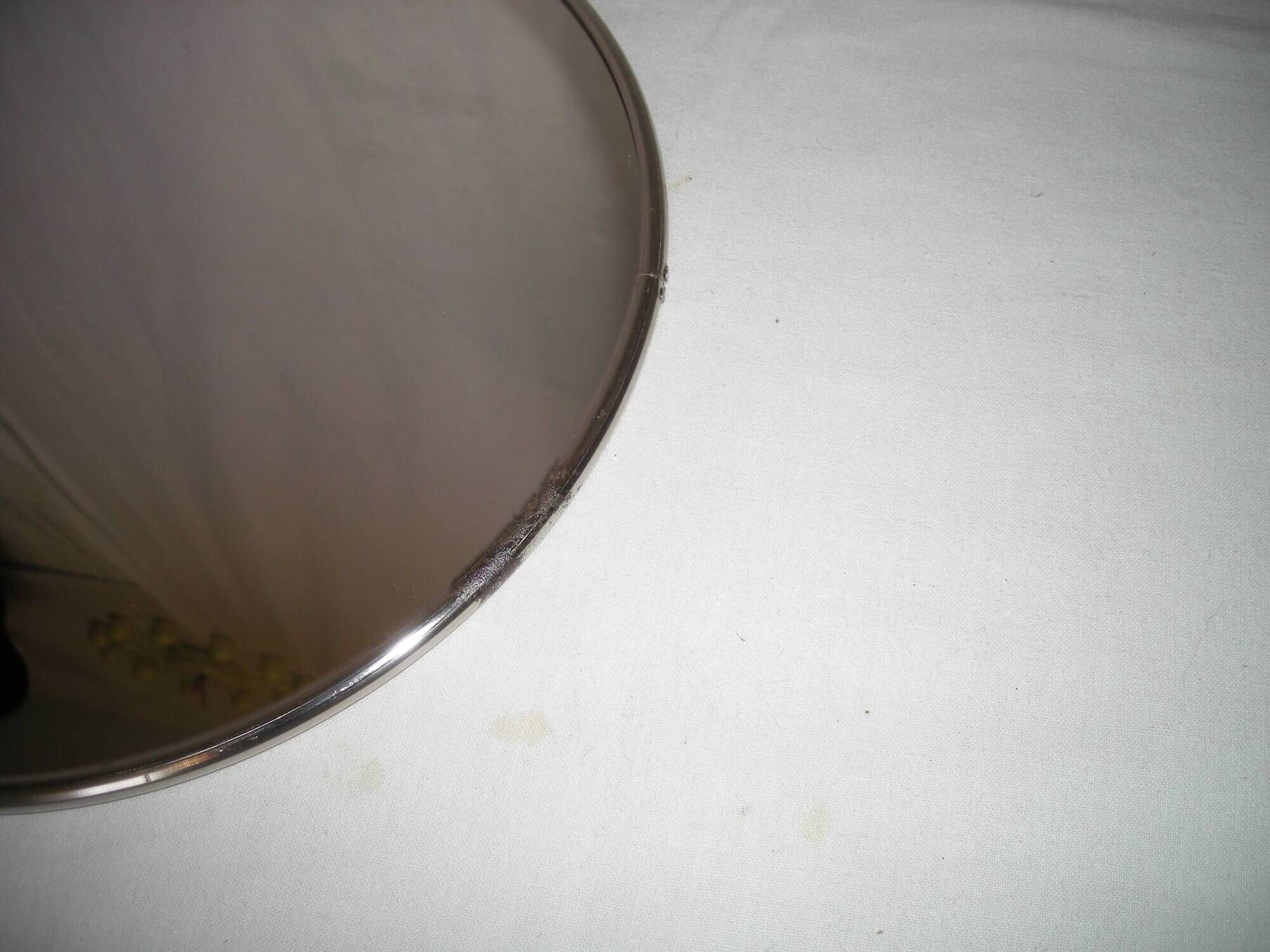 Round barber mirror with chain from the 1950s.