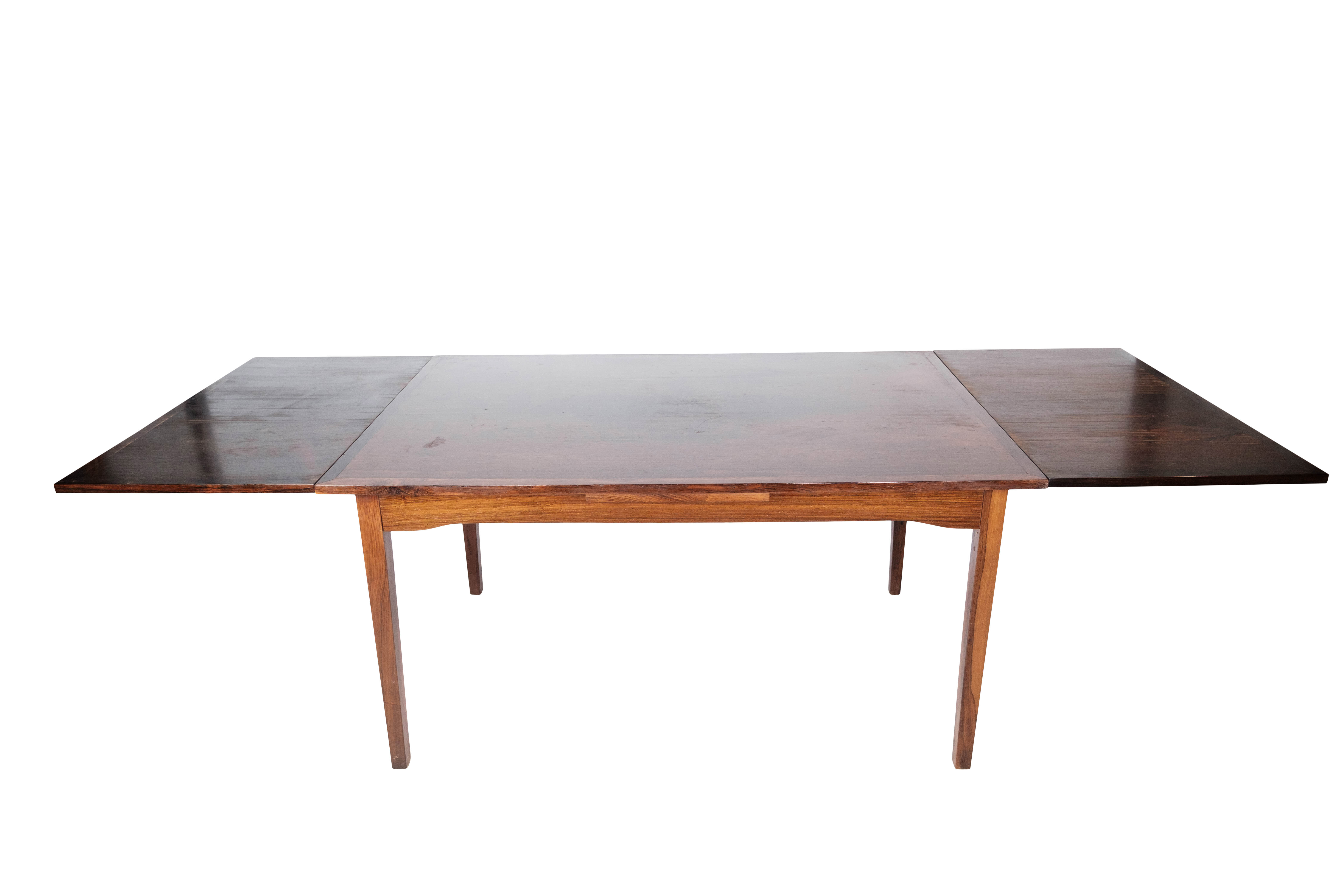 Dining table in rosewood with extension, of Danish design by Ellegaards Furniture, 1960s