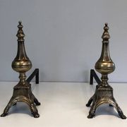 Pair of chiselled bronze and wrought iron fire dogs in the Louis XVI style.