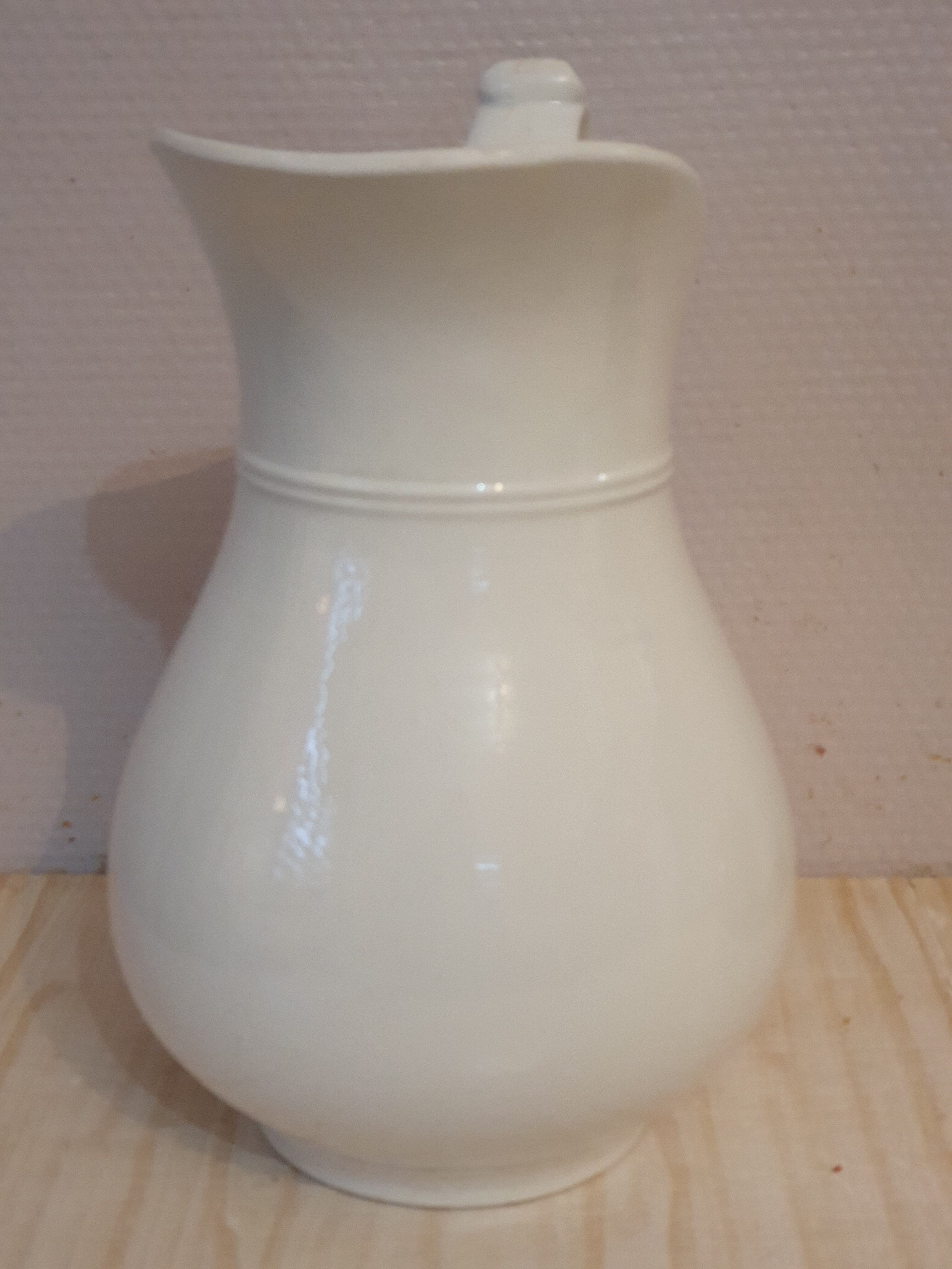 Antique pitcher pitcher in white porcelain