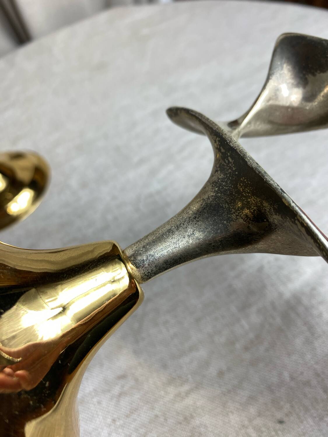 Pair of silver and gold metal candlesticks