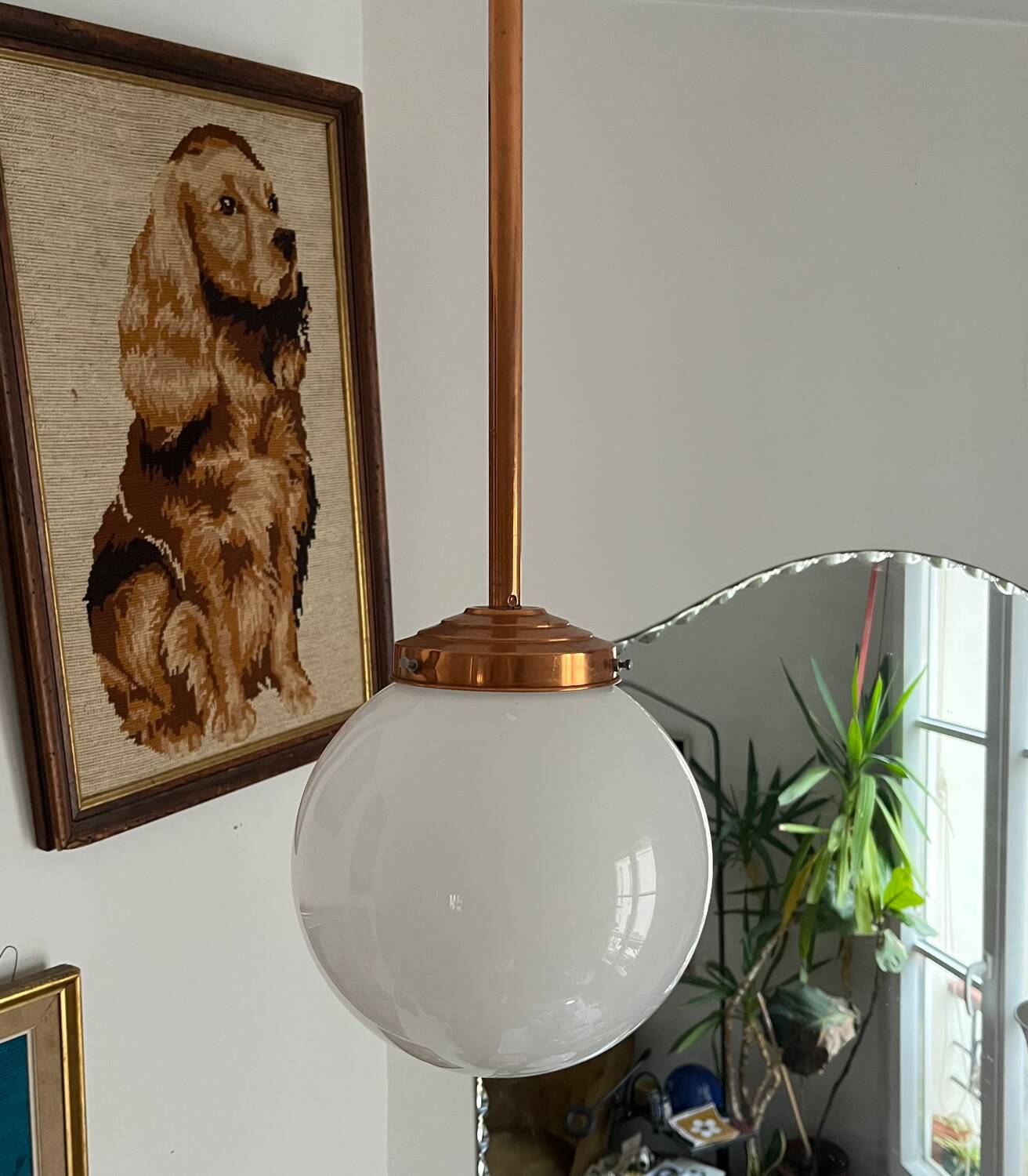 Opaline white globe pendant light with metal stem, Art Deco style.