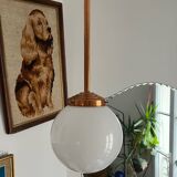 Opaline white globe pendant light with metal stem, Art Deco style.