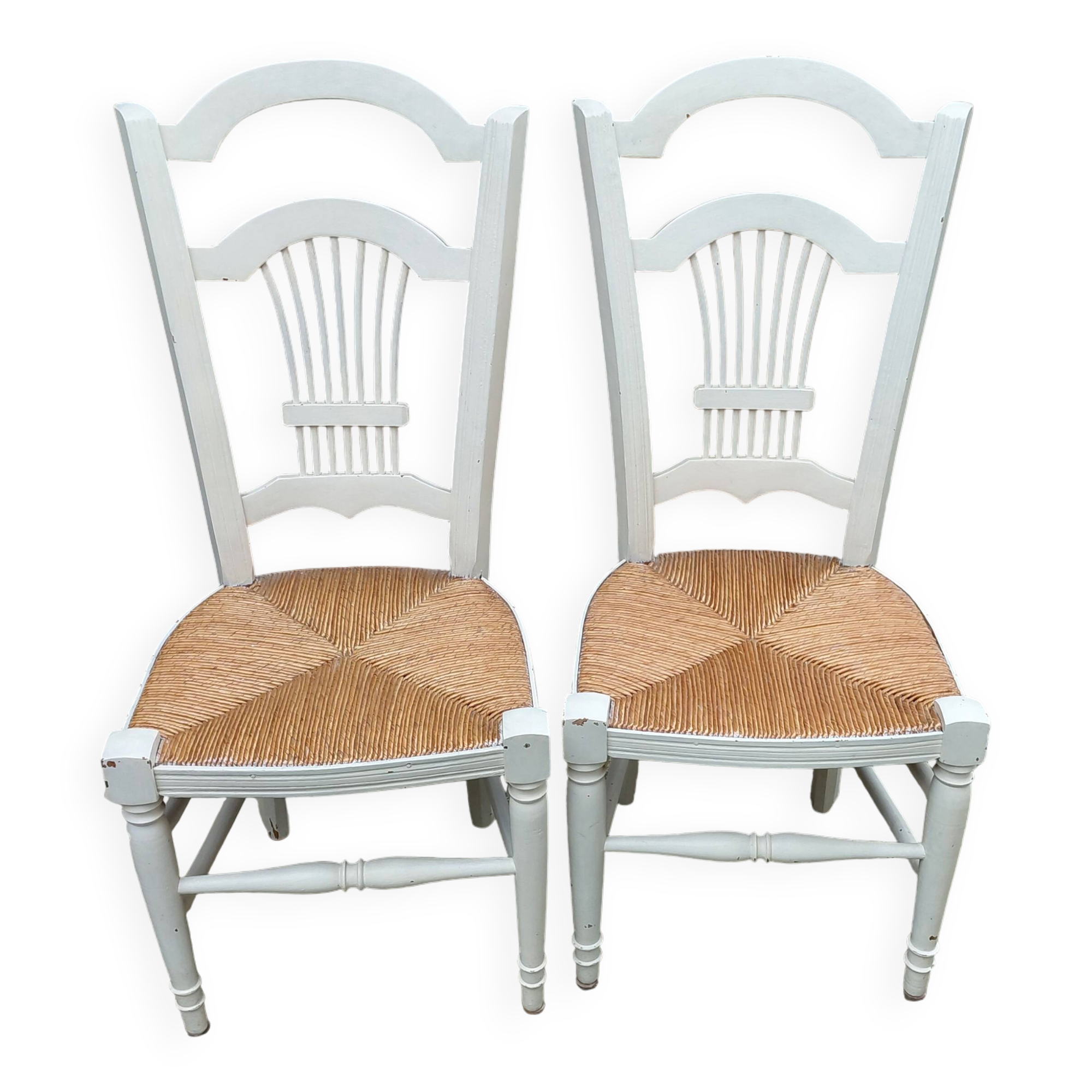 Pair of straw-seated chairs with white-stained wood.