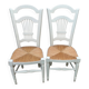 Pair of straw-seated chairs with white-stained wood.