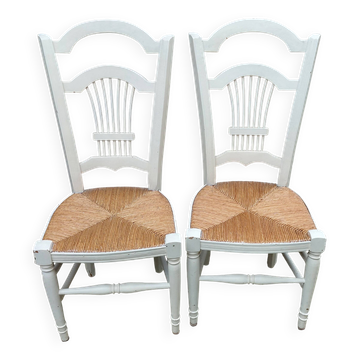 Pair of straw-seated chairs with white stained wood.