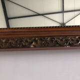 Old mirror with wooden frame and plaster moldings