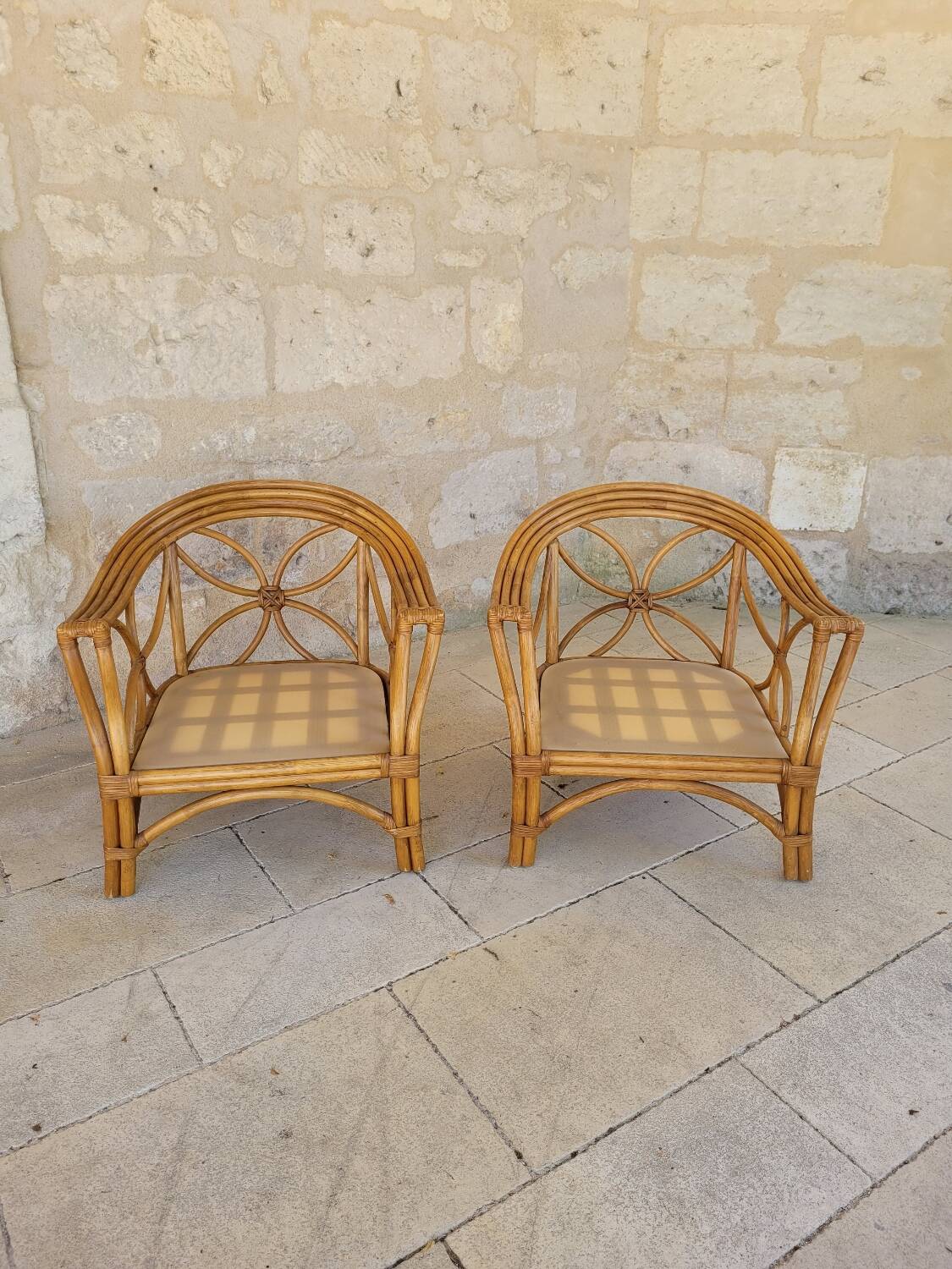Two large rattan armchairs