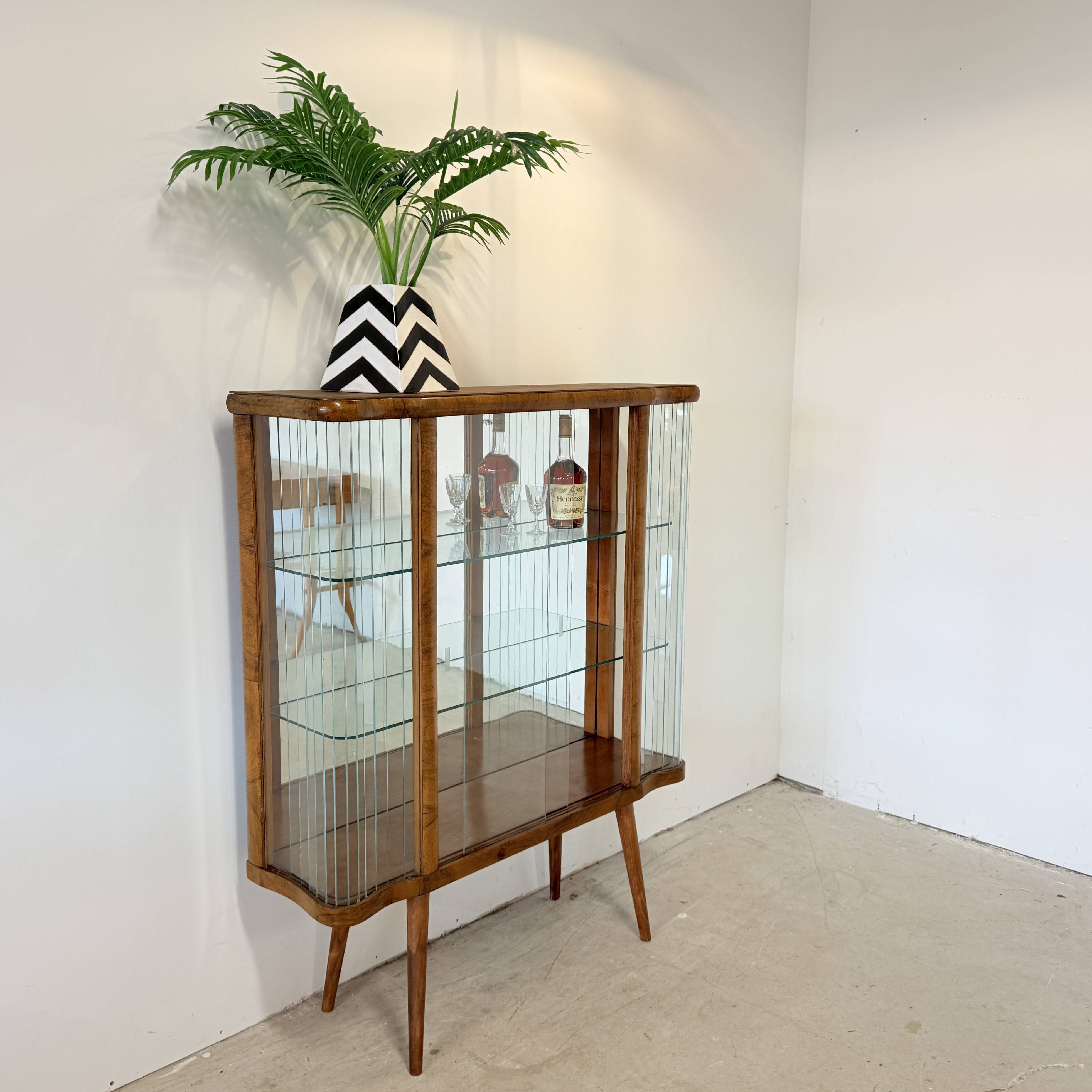 Elegant, curved display cabinet in Art Deco style