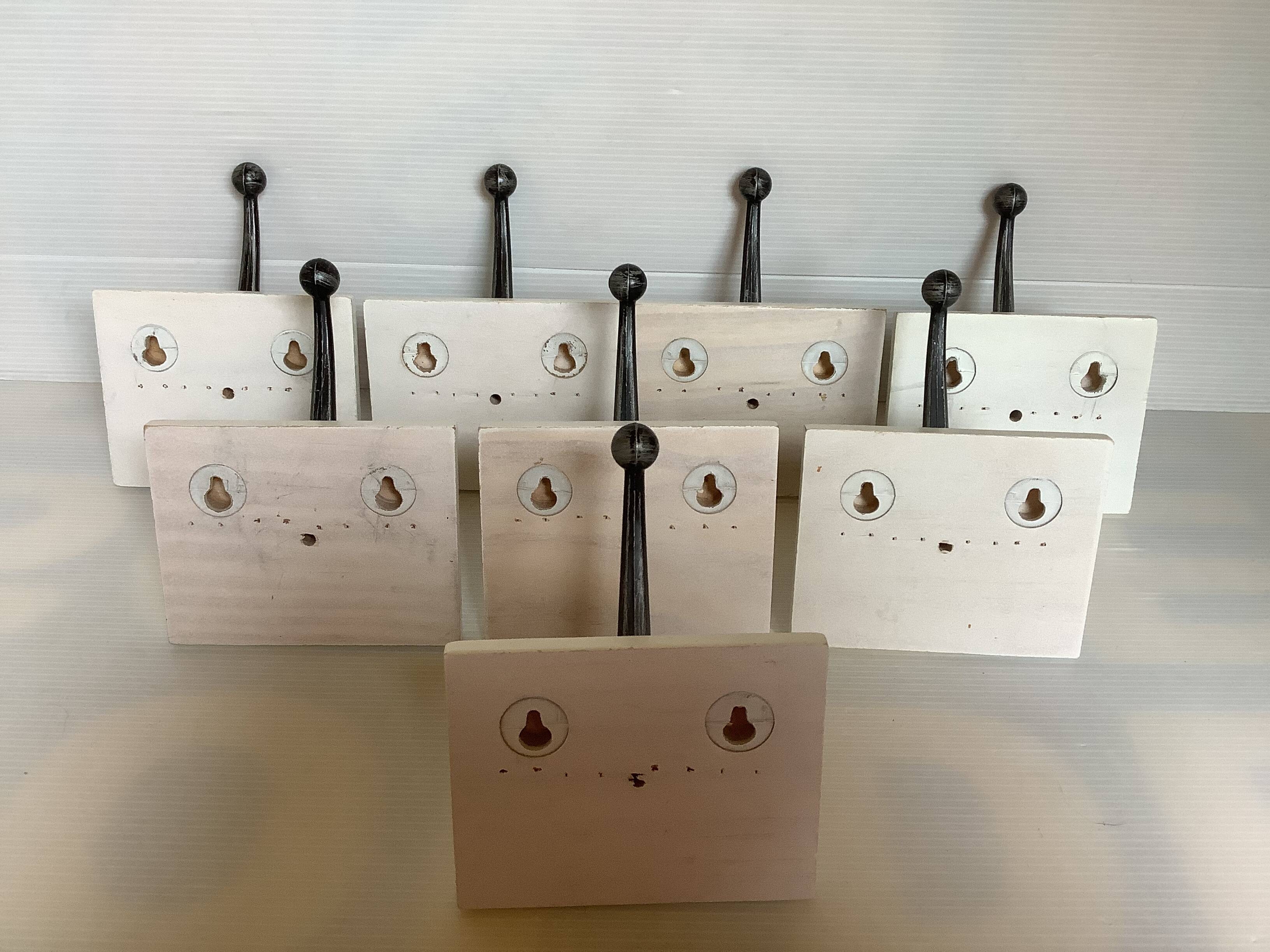 Eight double white wood metal hooks