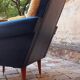 Pair of vintage 60s armchairs in black imitation leather and mustard toffee