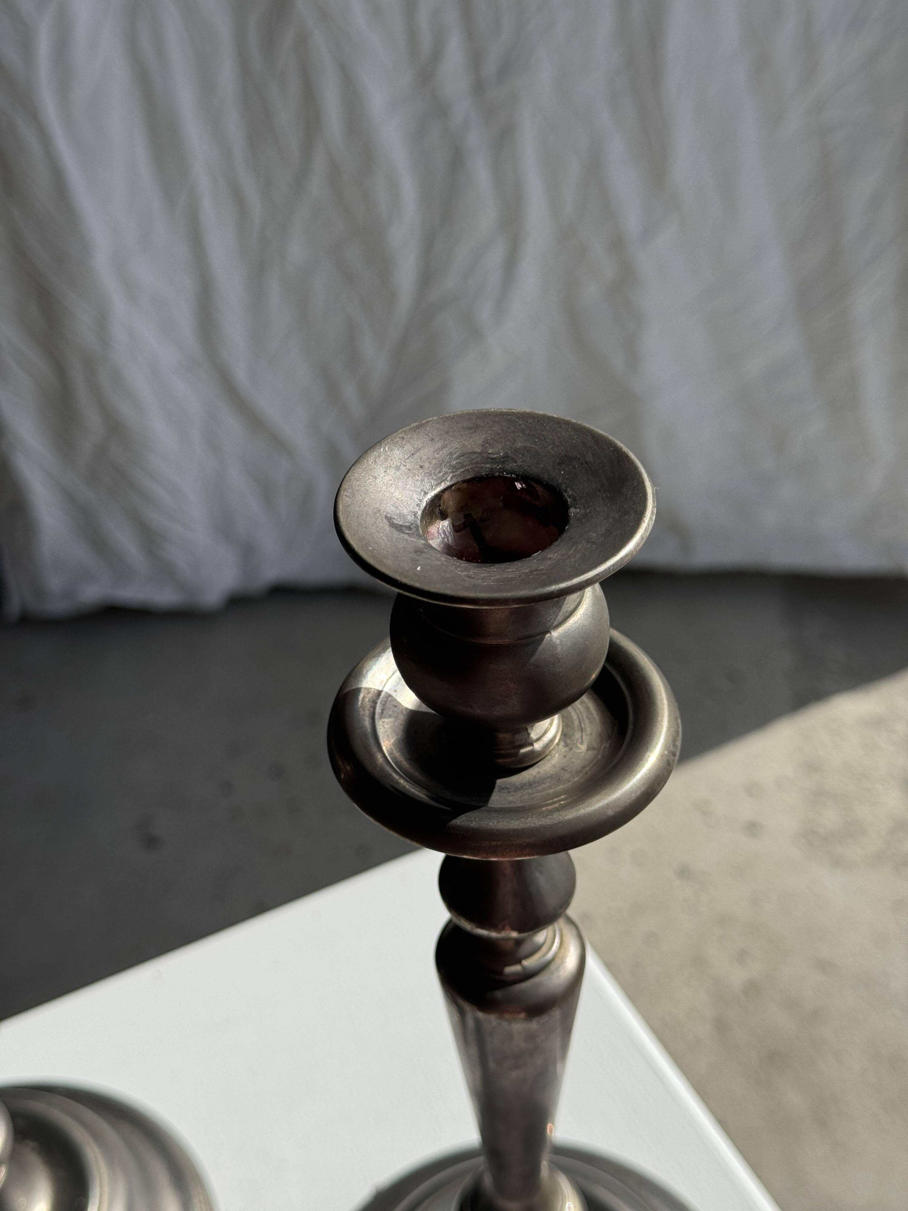 Two large antique silver-plated metal candlesticks, H30