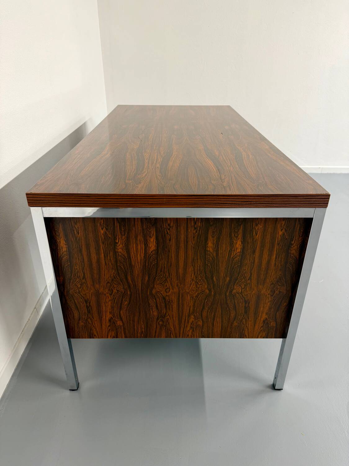 Vintage desk with rosewood veneer and chrome metal design from the 1970s.