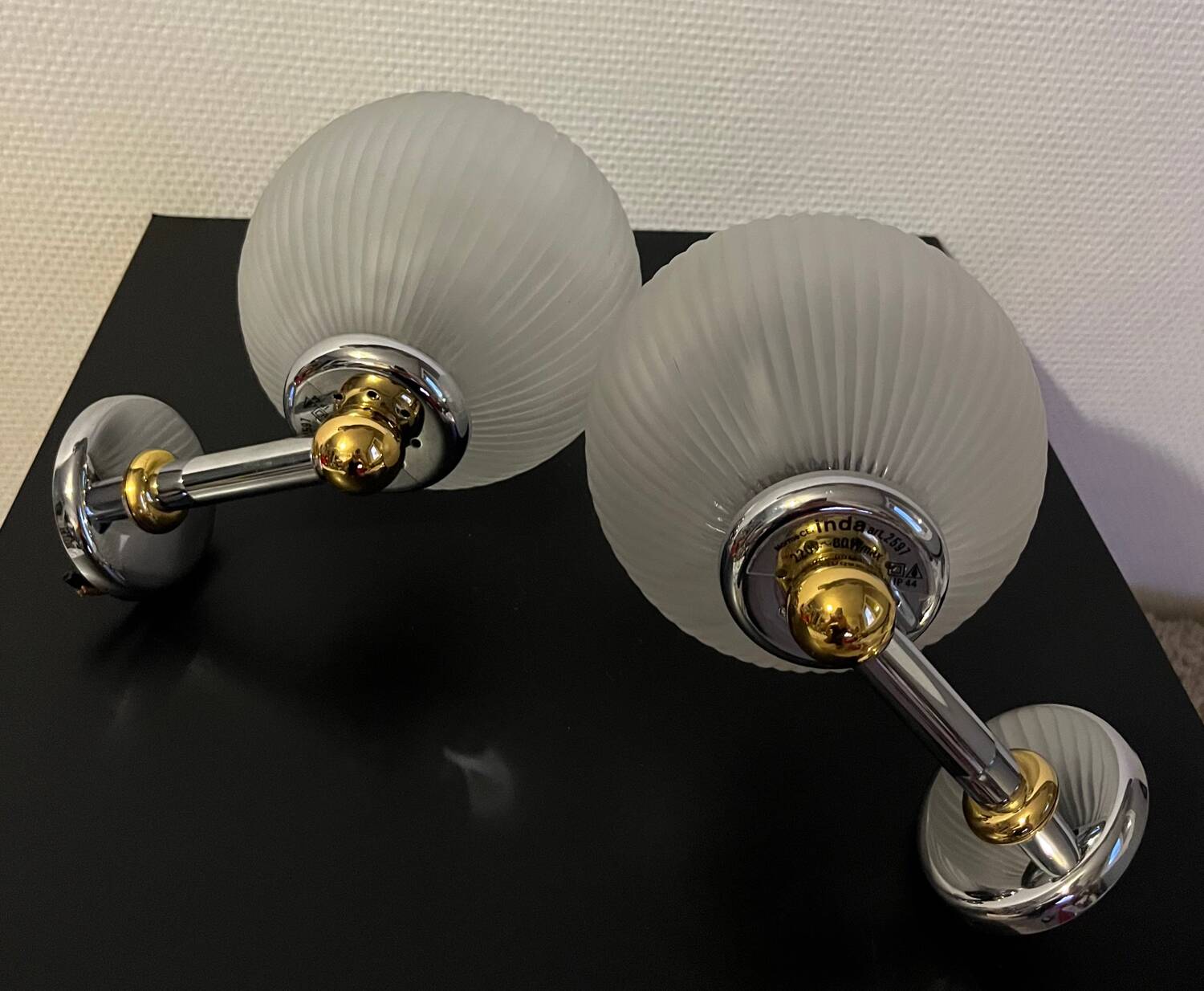 Pair of Inda metal and chiseled glass wall lights