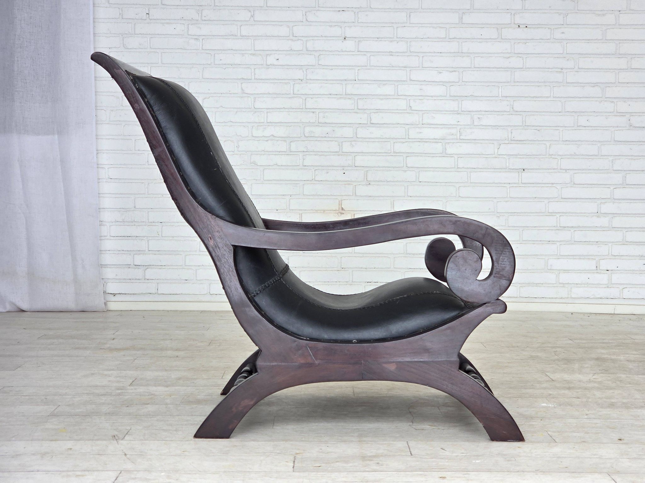 1970s, vintage armchair with footstool, black furniture leather.