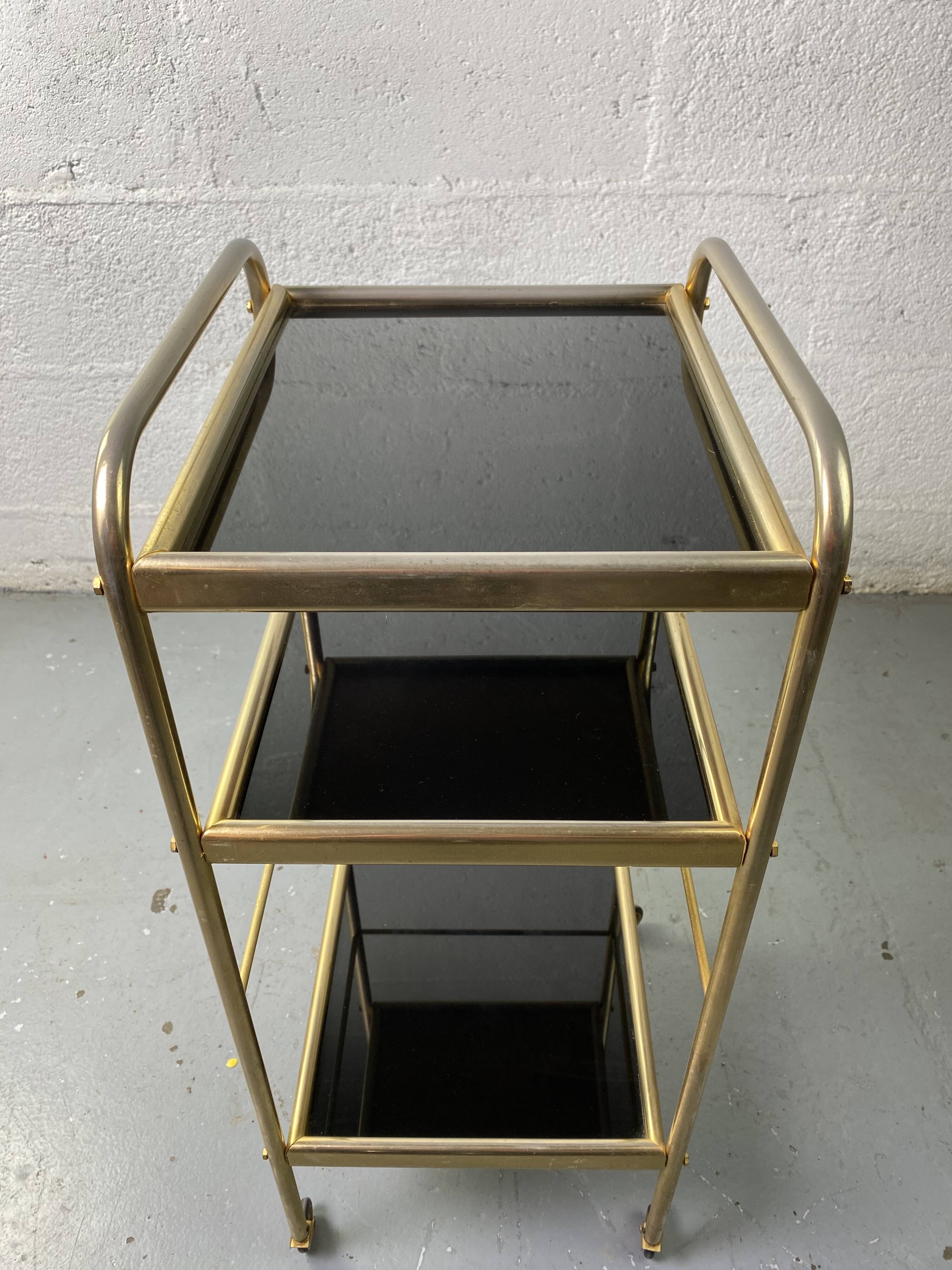 Small rolling trolley in brass and black plastic