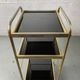 Small rolling trolley in brass and black plastic