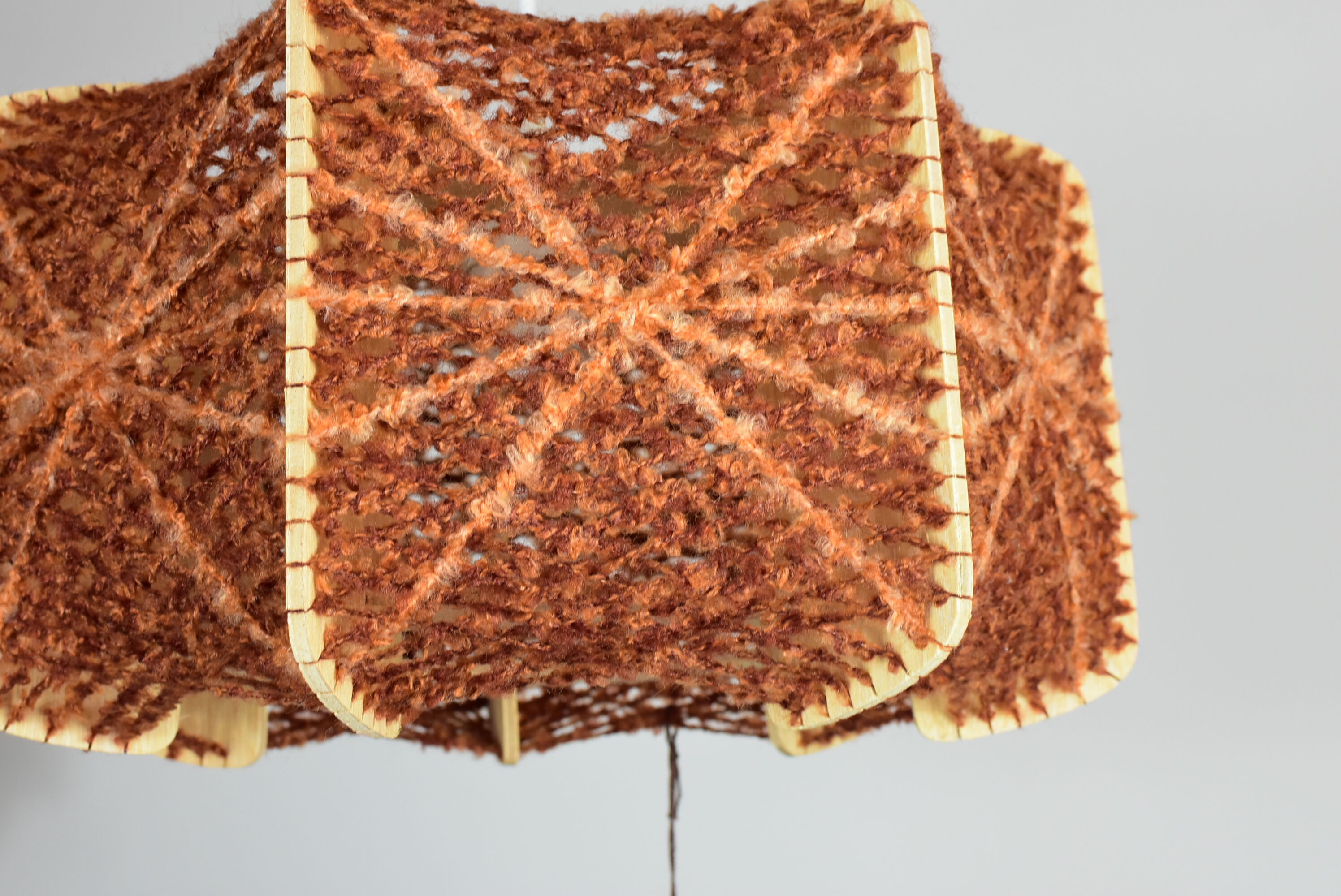 Brown wire and wood pendant light.