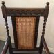 Fauteuil en bois sculpté et cannage