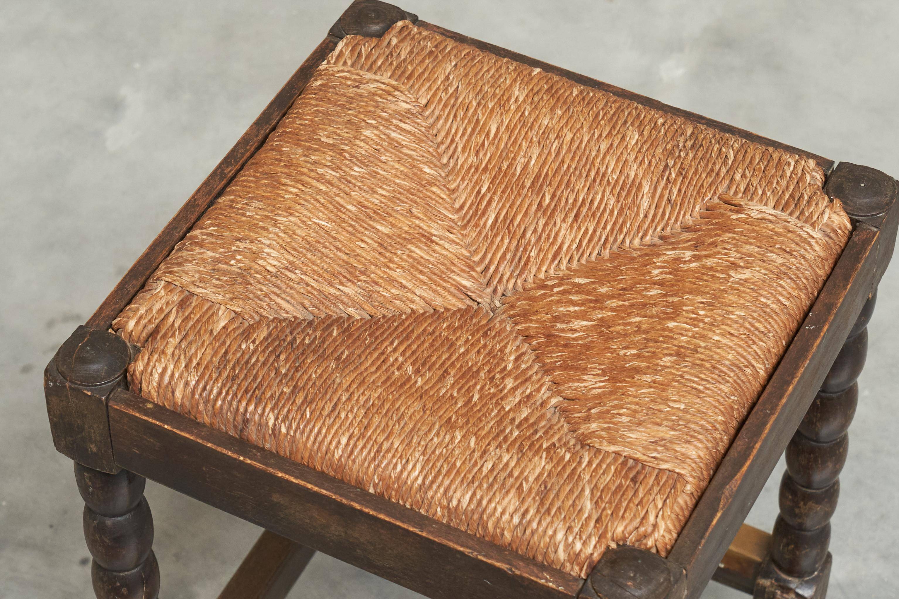 Solid oak stool, straw and brass from the 1920s.