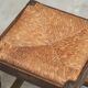 Solid oak stool, straw and brass from the 1920s.