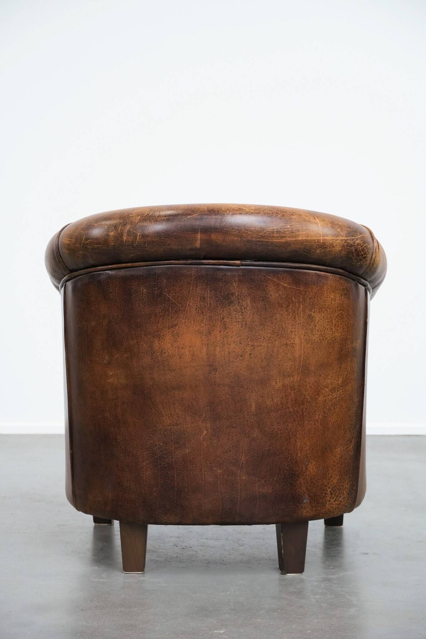 Vintage club chair in sheepskin leather with a characterful look