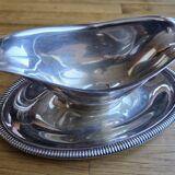 Silver-plated metal gravy boat on a stand