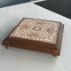 Vintage wooden and antique earthenware trivet, brown tile design